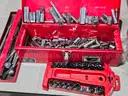 Tool box of various loose sockets, wrenches and ratchets.