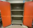 Rolling metal cabinet. About 65&#x22; tall, 26&#x22; deep, and 37&#x22; wide.