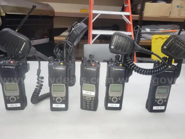 5 Motorola XTL 5000 Mobile Radios and 6 bank charging station