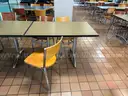 Various furniture items that were once used in a lounge space / cafeteria including chairs, tables