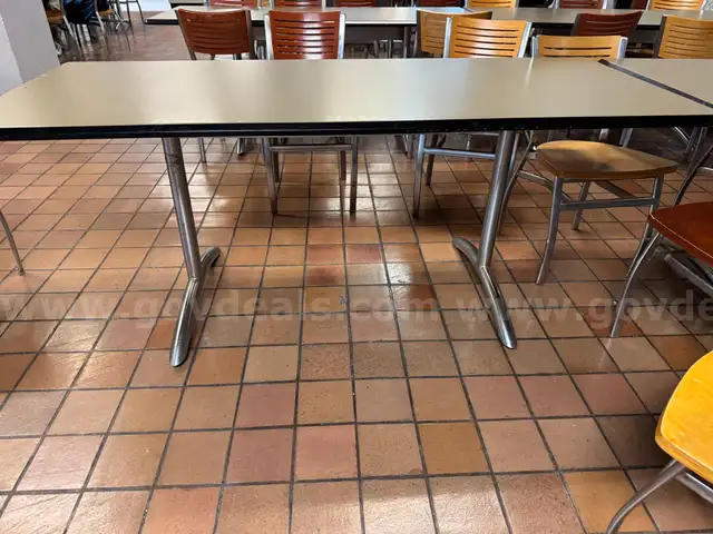 Various furniture items that were once used in a lounge space / cafeteria including chairs, tables