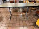 Various furniture items that were once used in a lounge space / cafeteria including chairs, tables
