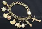 14k Yellow Gold Charm Bracelet with 9- 18k and 14k Charms, 49.5 Grams
