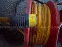 Two reels, 20a, 125v, 10-3 electric cords with NEMA Twist-lock plugs