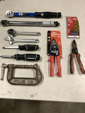 Lot of misc box items-2 torque wrenches, 2 crescent cutters, 2 Husky screwdrivers, 4 inch steel clamp, 7 drill bits,  DH