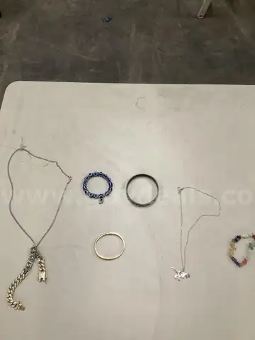 Lot of misc box items-Blue rocks wrist band, gold silver diamond wrist band, silver Dinosaur necklace,  &#x22;DH&#x22;