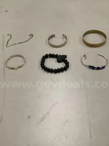 Lot of misc box items-All black rocks wrist band, gold design wrist band, gold diamond necklace,  &#x22;DH&#x22;