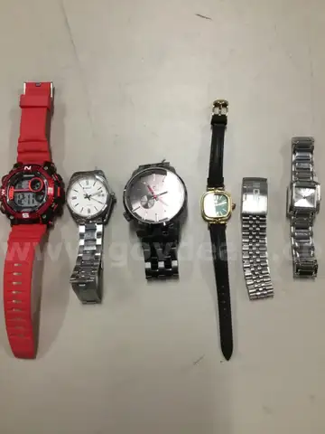 Lot of misc box items-red Armitron watch, silver Casio watch, black Rip Curl watch, silver Leo II bracelet  &#x201C;DH&#x201D;