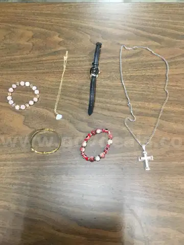 Lot of misc box items-black Geneva watch, silver diamond cross necklace, gold snap on band, pink rocks wrist band  &#x201C;DH&#x201D;