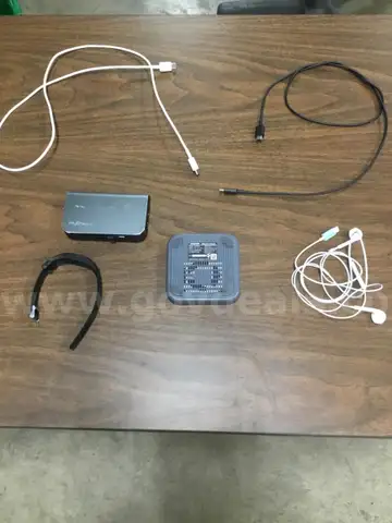 Lot of misc box items-black & white usb chargers, white earplugs, dark gray wireless charger, a watch  “DH”