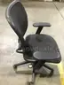 Black mesh adjustable office chair; black padded armrests  “DH”