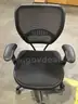 Black mesh adjustable office chair; black padded armrests  “DH”