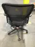 Black mesh adjustable office chair; black padded armrests  “DH”