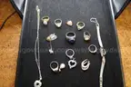 PAIR OF EARRINGS (1), CHARMS (6), WATCH (1), PIN (1), RINGS (8), NECKALACE (1)