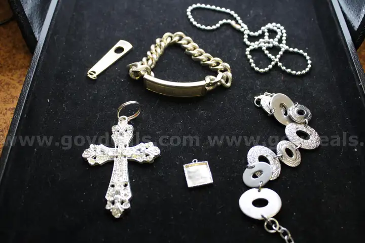 BRACELET (2); NECKLACE WITH CROSS (1); CHARMS (2)