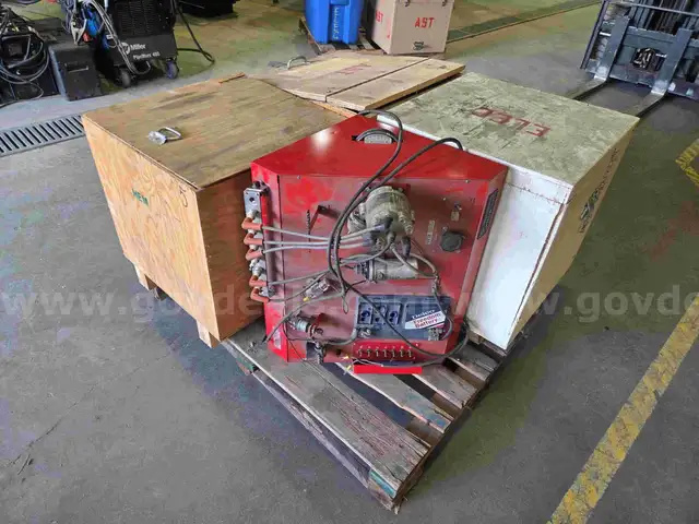 Pallet of used automatic transmission parts, automotive electrical components, and automotive ignition system trainer.