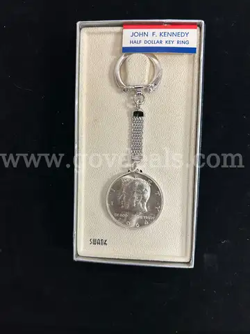 TWO JEWELRY ITEMS: (1) MANS MASONIC RING, GOLD IN COLR WITH RED SET; (1) KEY CHAIN, SILVER IN COLOR WTIH 1964 KENNEDY HA