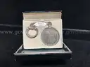 KEY CHAIN WITH MORGAN DOLLAR AND TAG WITH "RUBY 1962" INSCRIBED, IN BOX
