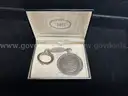 KEY CHAIN WITH MORGAN DOLLAR AND TAG WITH "RUBY 1962" INSCRIBED, IN BOX
