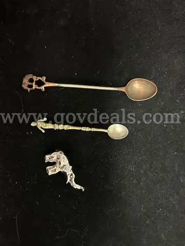THREE MISC ITEMS: (2) SMALL DECORATIVE SPOONS, SILVER AND BRASS IN COLOR; (1) MINITURE ELEPHANT, SILVER IN COLOR