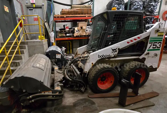 Bobcat 753 Skid Steer Loader with broom, scoop, and brush cat attachments