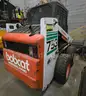 Bobcat 753 Skid Steer Loader with broom, scoop, and brush cat attachments