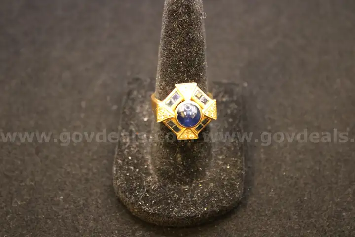 Gold colored ring with  multiple colored stones and multiple clear stones