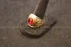 Gold colored ring with a colored stone