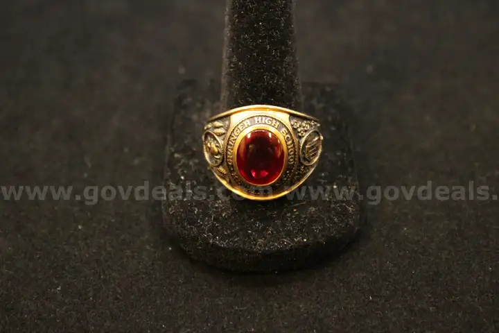 Gold colored ring with a colored stone