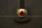 Gold colored ring with a colored stone