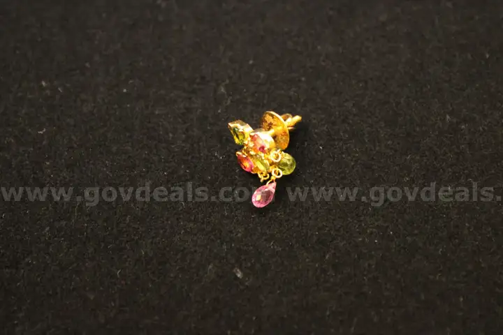 Gold colored earring with multiple colored stones
