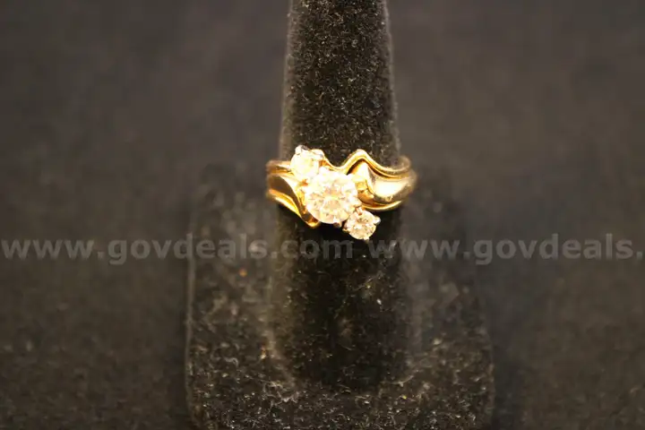 Gold colored ring with multiple clear stones