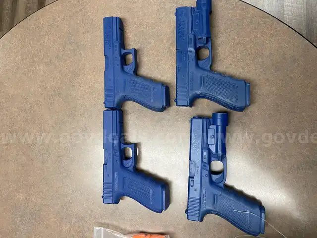Blank training rounds, Glock 21 magazines, and blue molded Glock G21 guns
