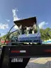 Heavy duty trailer with hydraulic arm