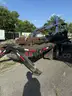 Heavy duty trailer with hydraulic arm