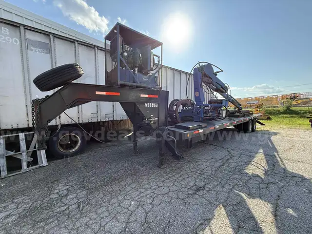 Heavy duty trailer with hydraulic arm
