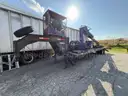 Heavy duty trailer with hydraulic arm