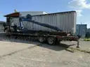 Heavy duty trailer with hydraulic arm