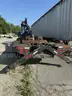 Heavy duty trailer with hydraulic arm