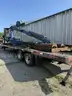 Heavy duty trailer with hydraulic arm