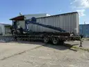 Heavy duty trailer with hydraulic arm