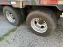 Heavy duty trailer with hydraulic arm