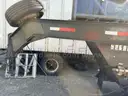 Heavy duty trailer with hydraulic arm