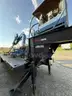 Heavy duty trailer with hydraulic arm