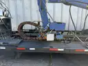 Heavy duty trailer with hydraulic arm