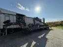 Heavy duty trailer with hydraulic arm