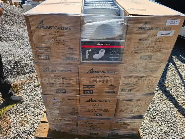 pallet of new white gutter supplies