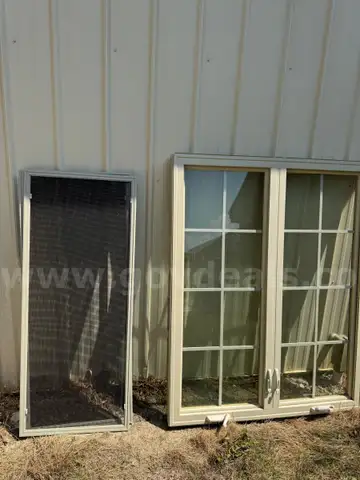Two large windows with crank outs on each side and a screen for each side