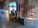 Electric forklift and charger - 1994 Yale ERC 030 3K-lbs. lift capability electric forklift and charger.