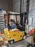 Electric forklift and charger - 1994 Yale ERC 030 3K-lbs. lift capability electric forklift and charger.